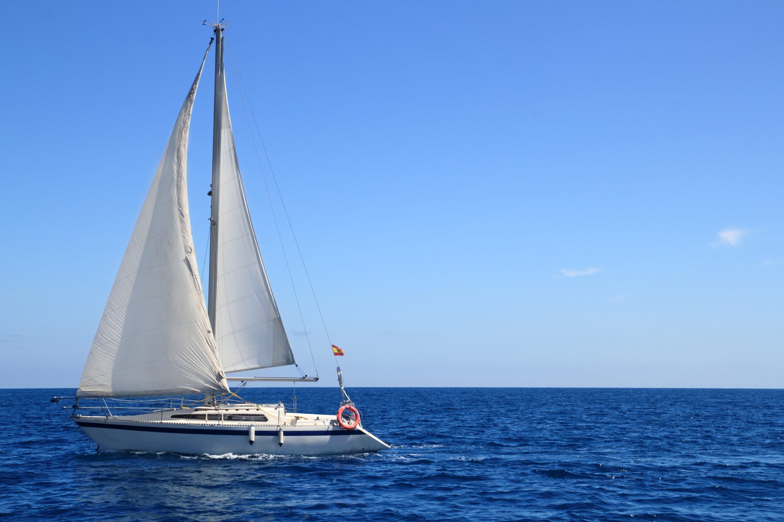 man riding on white and red boat on sea during daytime